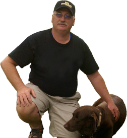Mike kneeling beside his chocolate lab